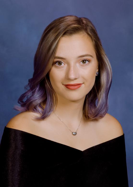 Senior  portrait on mottled blue at our studio in Richmond VA